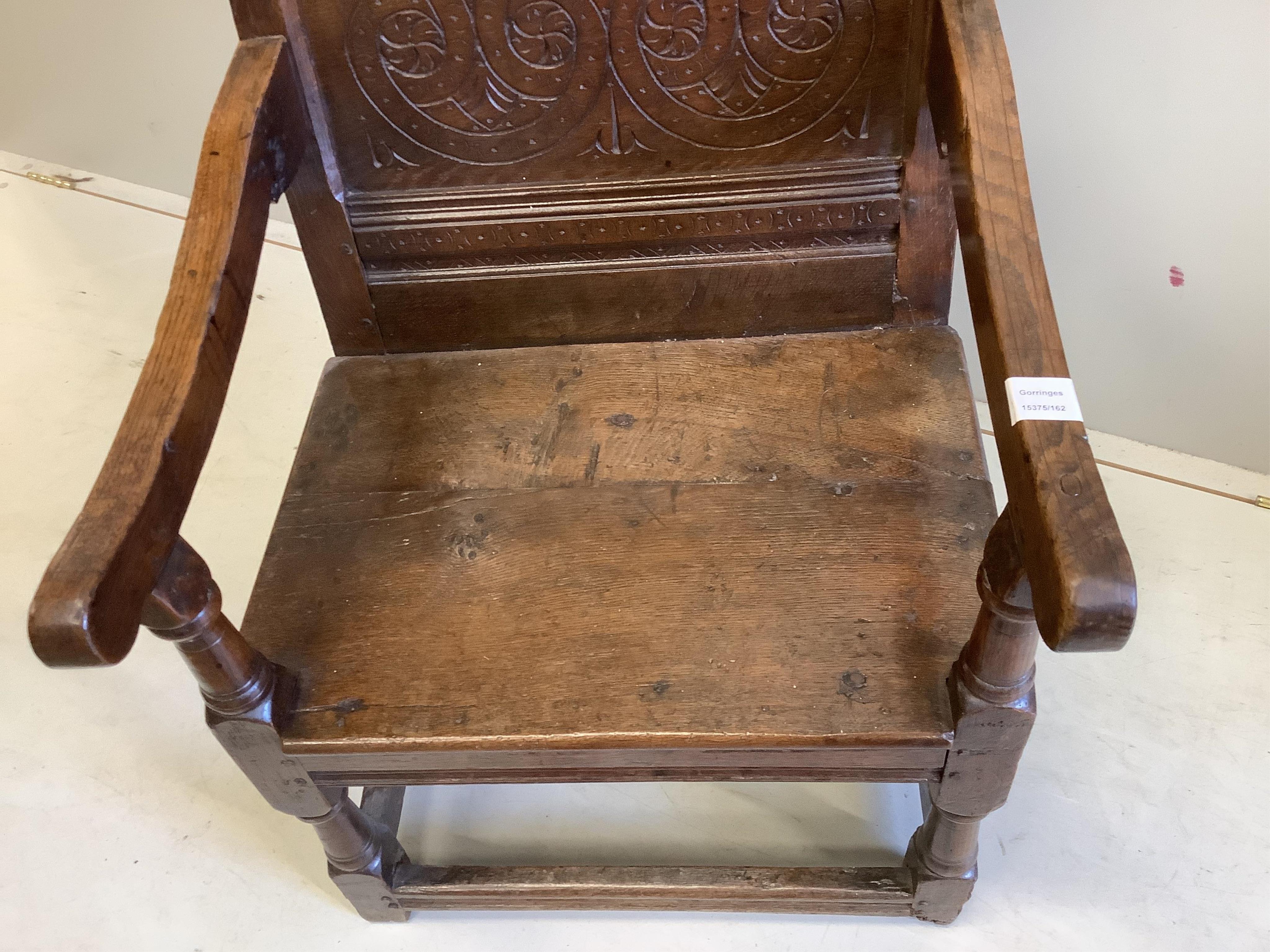 A 17th century carved oak wainscot elbow chair, width 57cm, depth 56cm, height 98cm. Condition - good